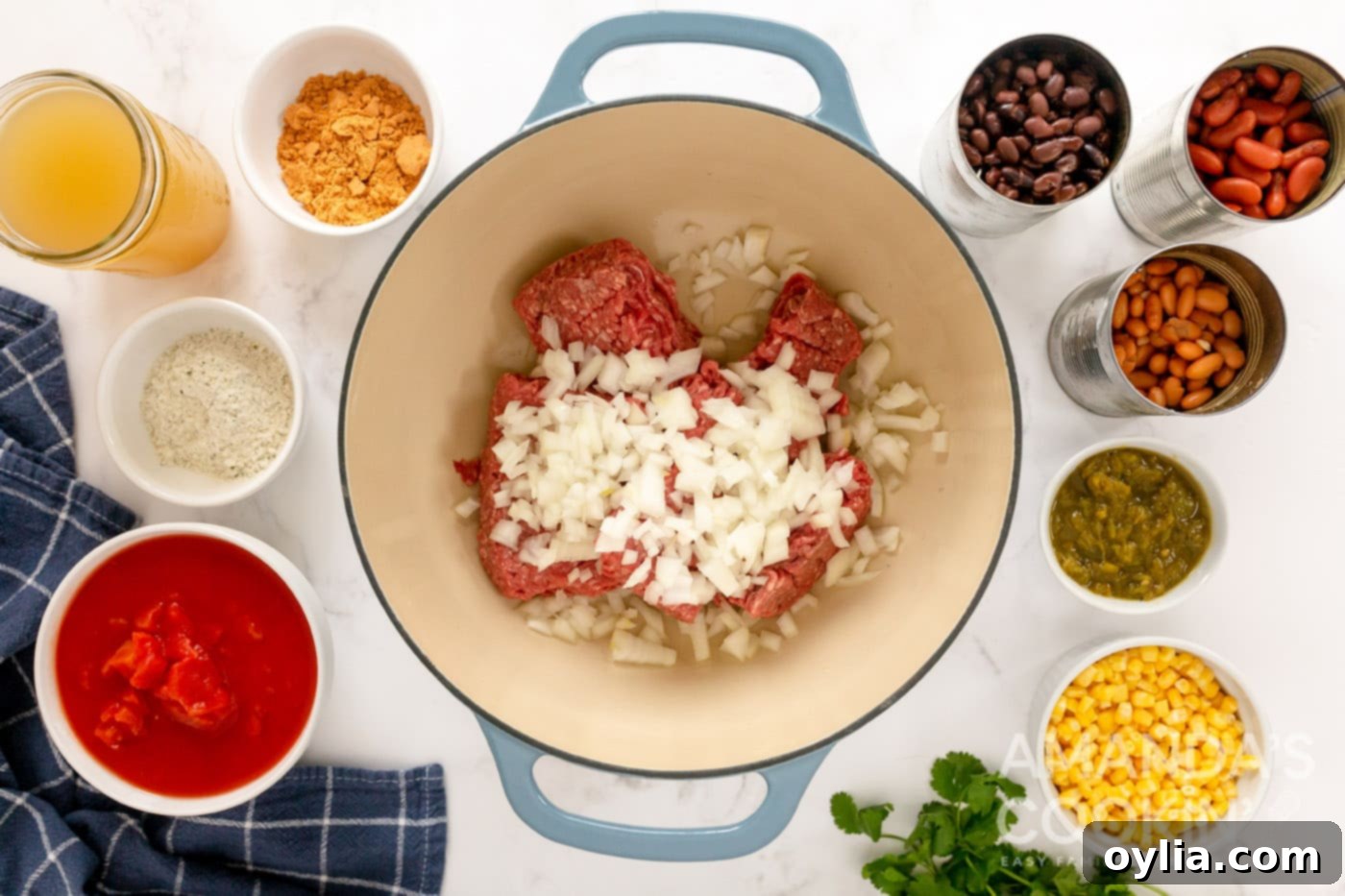 Browning lean ground beef and chopped onion together in a large Dutch oven over medium heat.