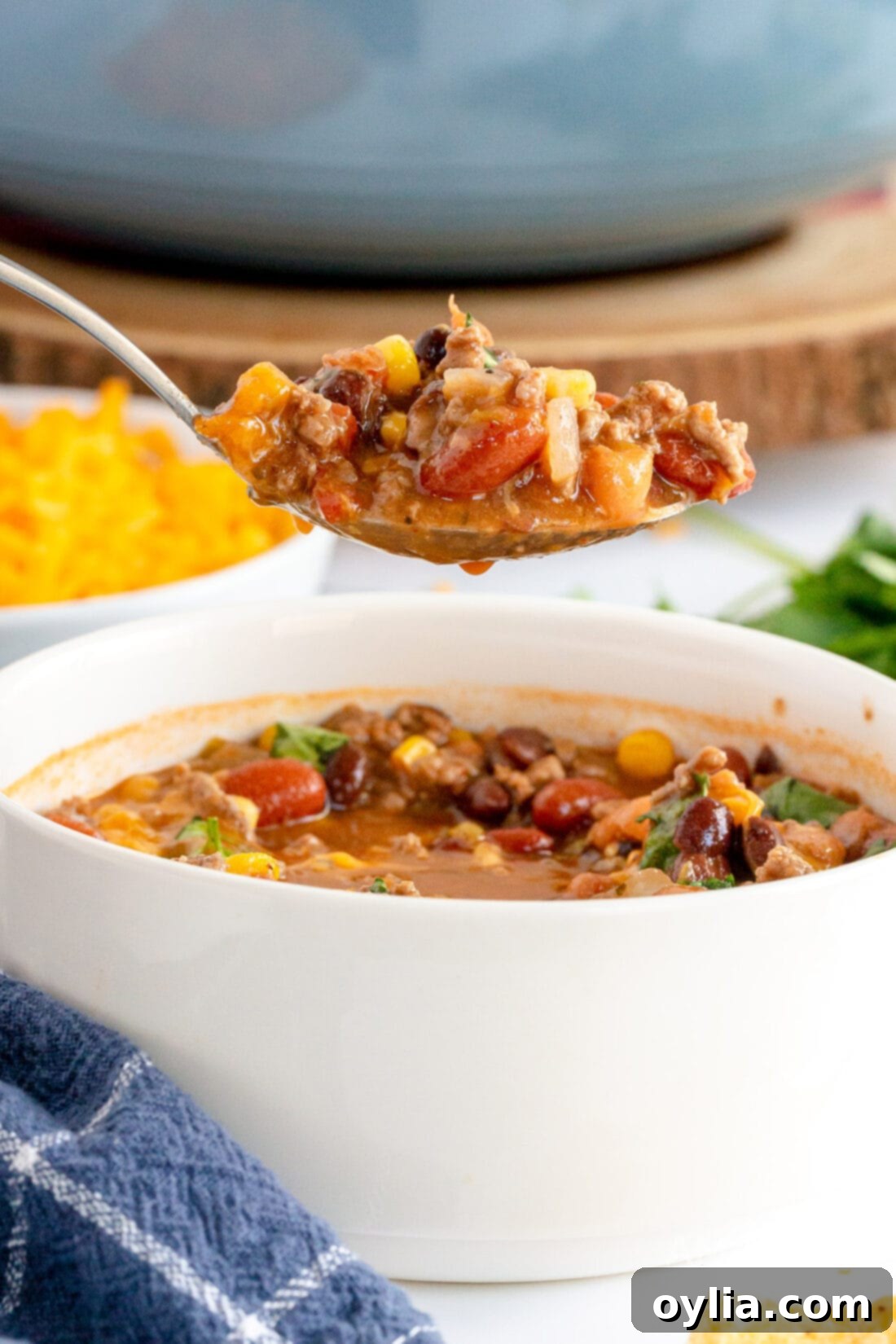 Ultimate Taco Soup 9 A spoon scooping up a generous portion of chunky taco soup, showing off the rich ingredients.