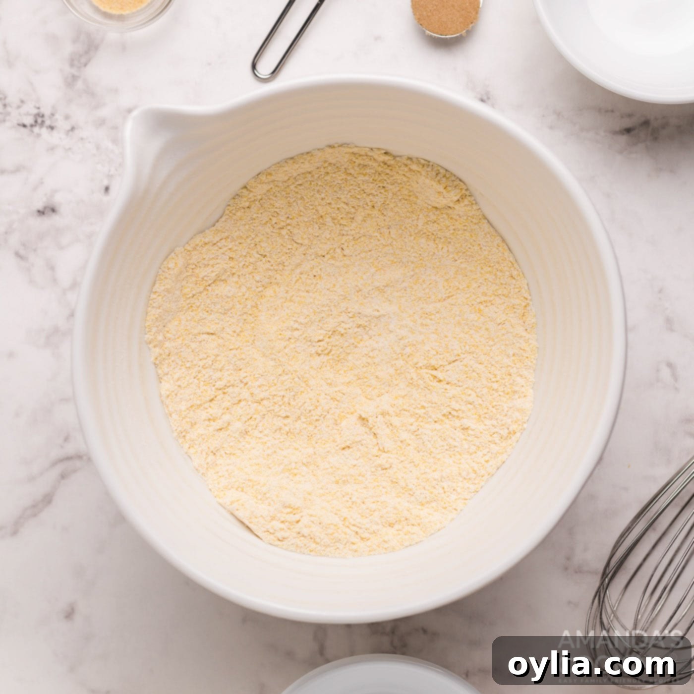 Cornbread muffin mixture in a bowl, showing the dry ingredients.
