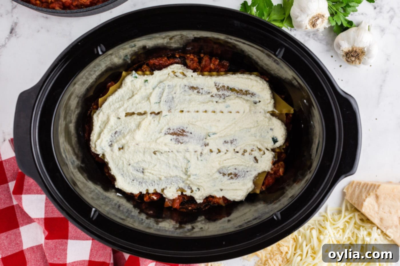 Set It and Forget It Lasagna 9 Creamy ricotta cheese mixture spread over the lasagna noodles in the slow cooker.