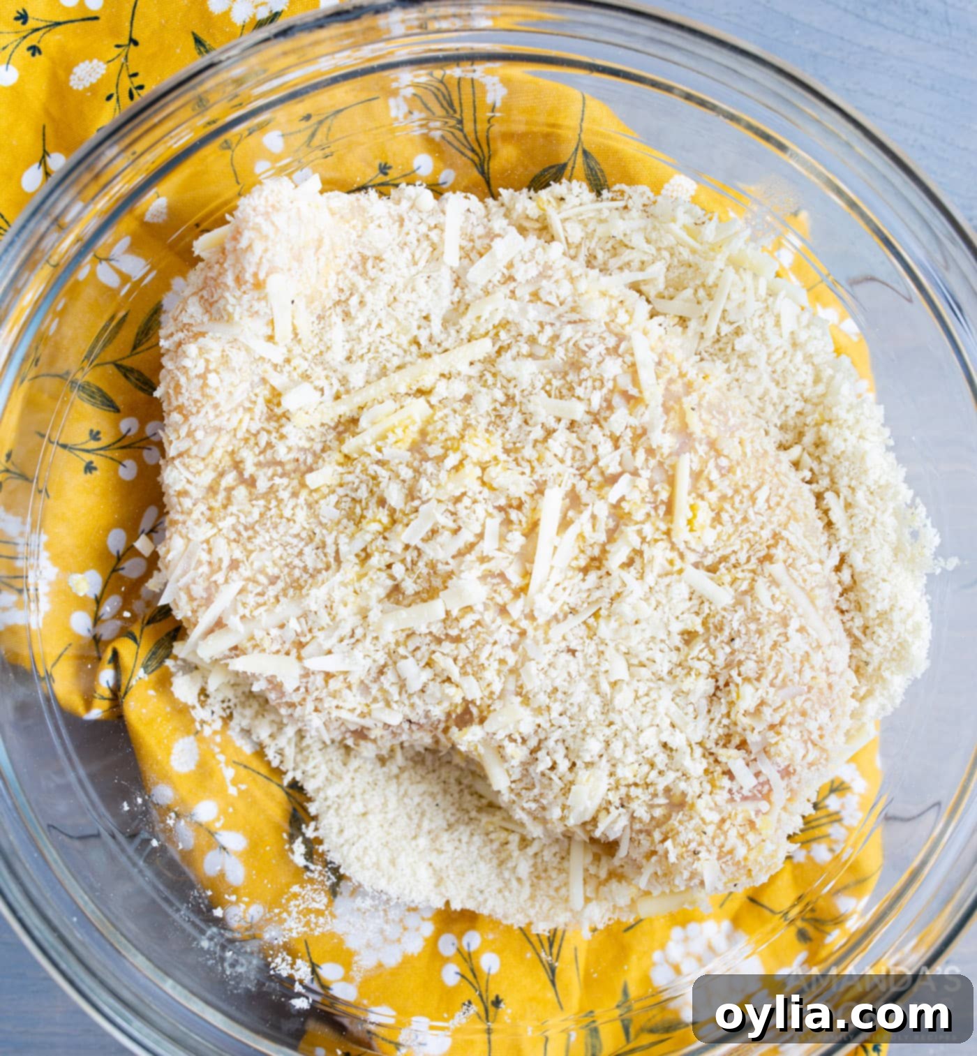 Crispy Air Fryer Chicken Parmesan 8 A chicken breast fully coated in panko breadcrumbs and Parmesan cheese, ready for air frying.