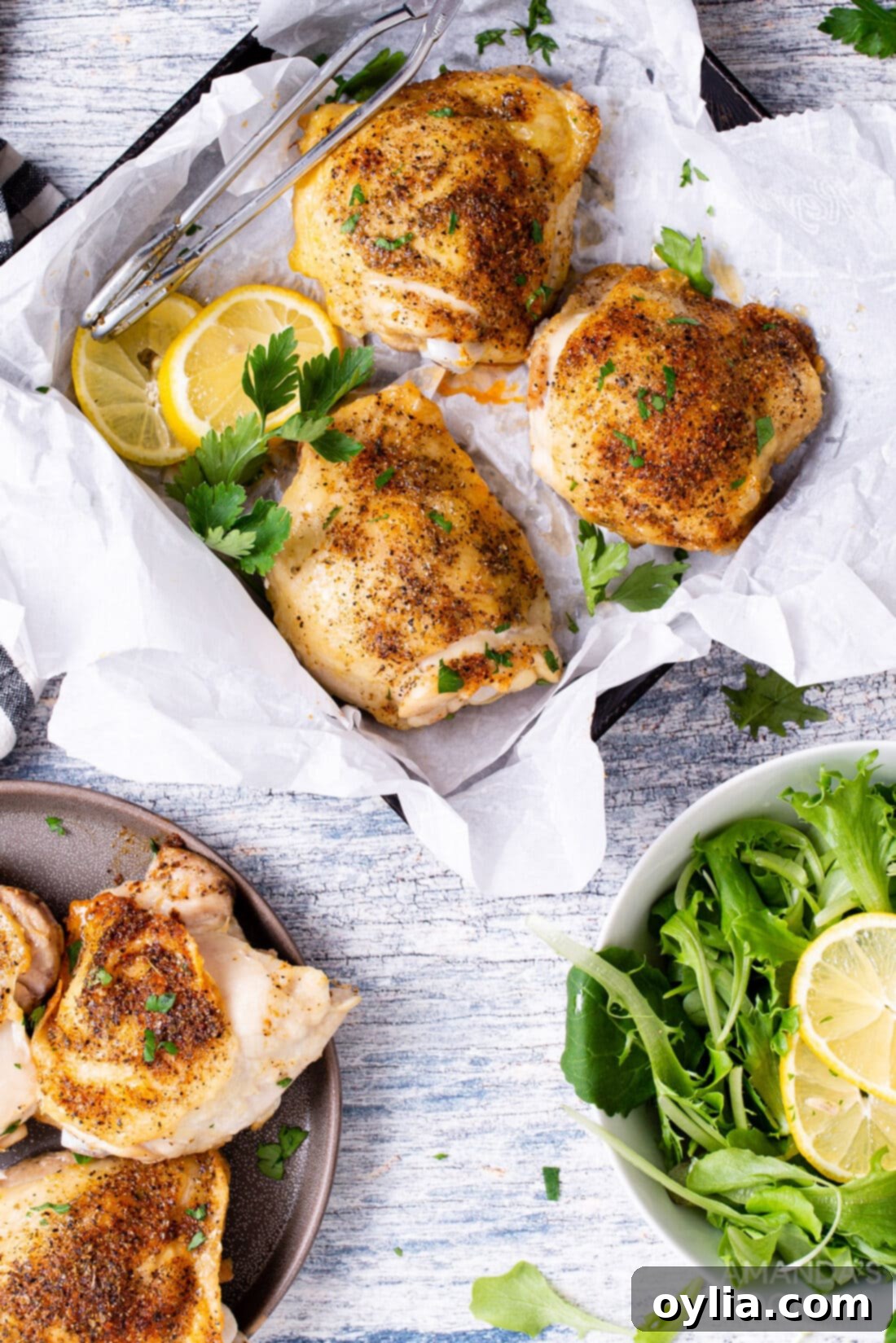 Crispy Air Fryer Chicken Thighs 3 air fryer chicken thighs served in a square dish with a side salad