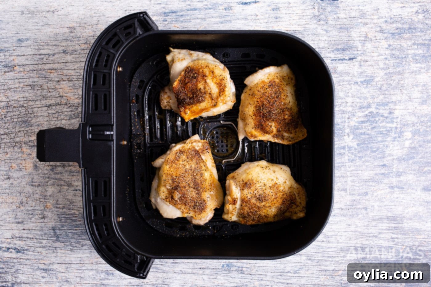 crispy air fryer chicken thighs after cooking, golden and ready to serve