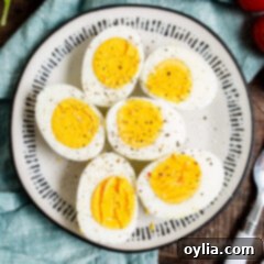 Your Go To Air Fryer Hard Boiled Eggs 9 Perfectly halved air fryer hard boiled eggs on a plate, ready to be enjoyed.