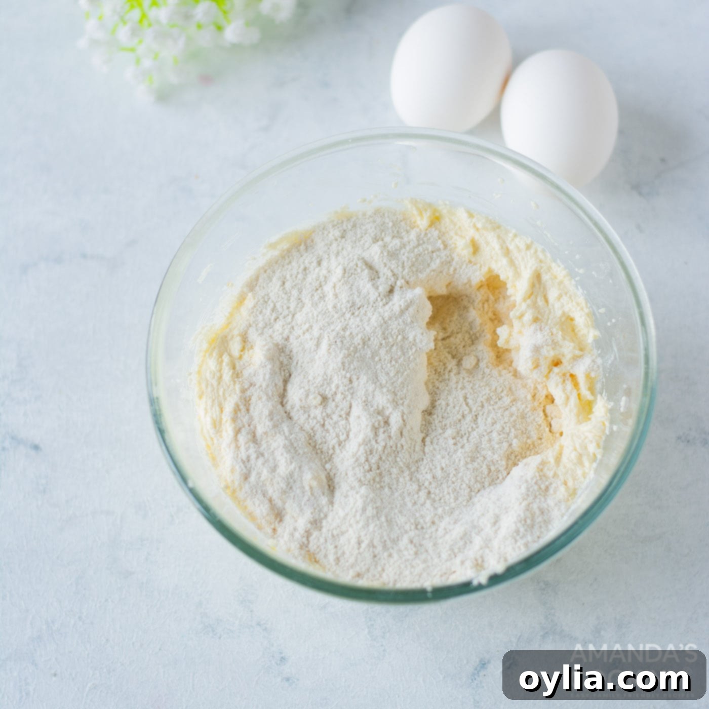A bowl containing a dry mix of almond flour, all-purpose flour, salt, and cinnamon, perfectly prepared for adding to the wet ingredients.