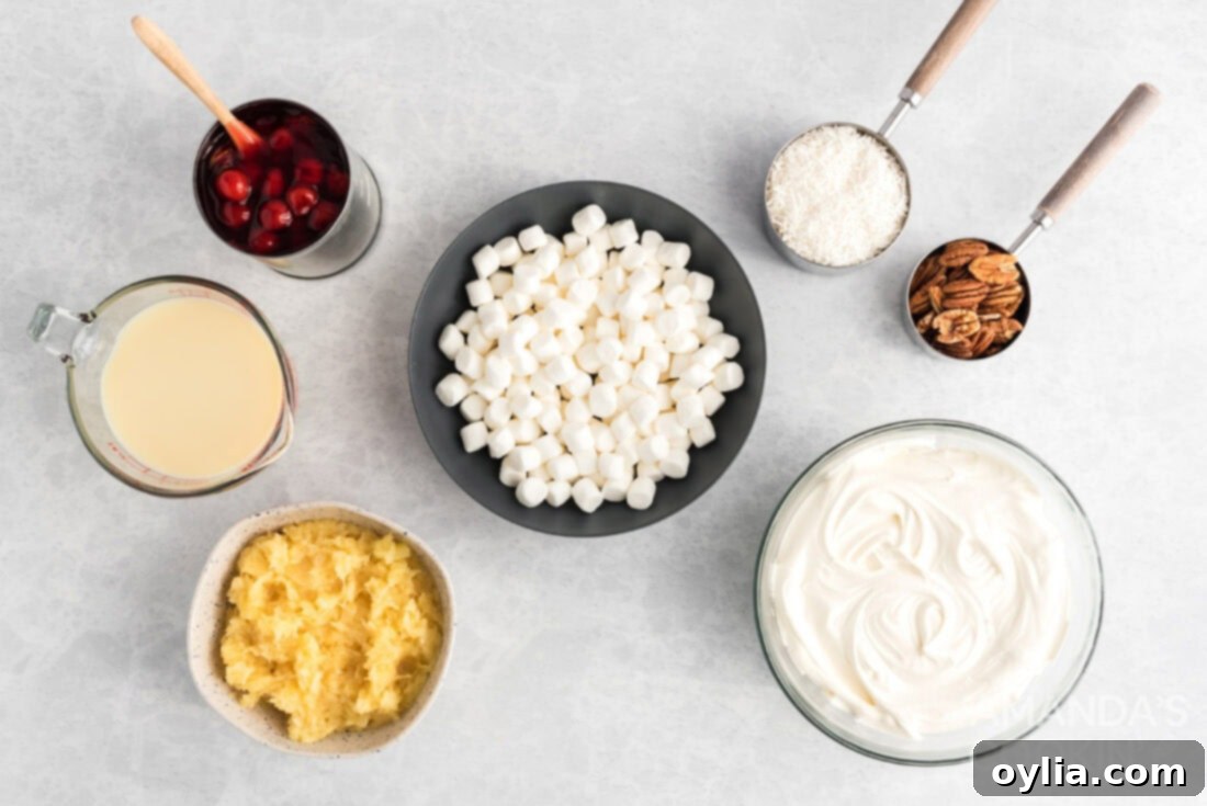 A flat lay photo showing the ingredients for cherry fluff: crushed pineapple, sweetened condensed milk, cool whip, cherry pie filling, and miniature marshmallows.