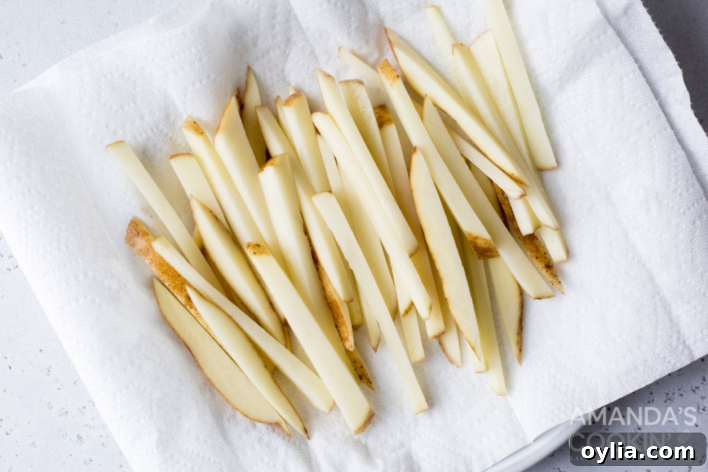 potato slices drying on a paper towel