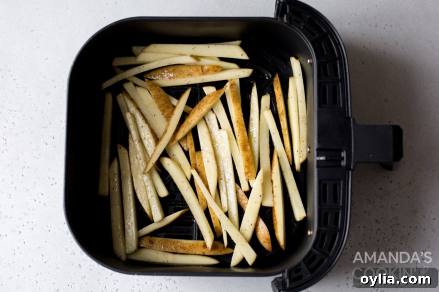 potato slices in air fryer basket