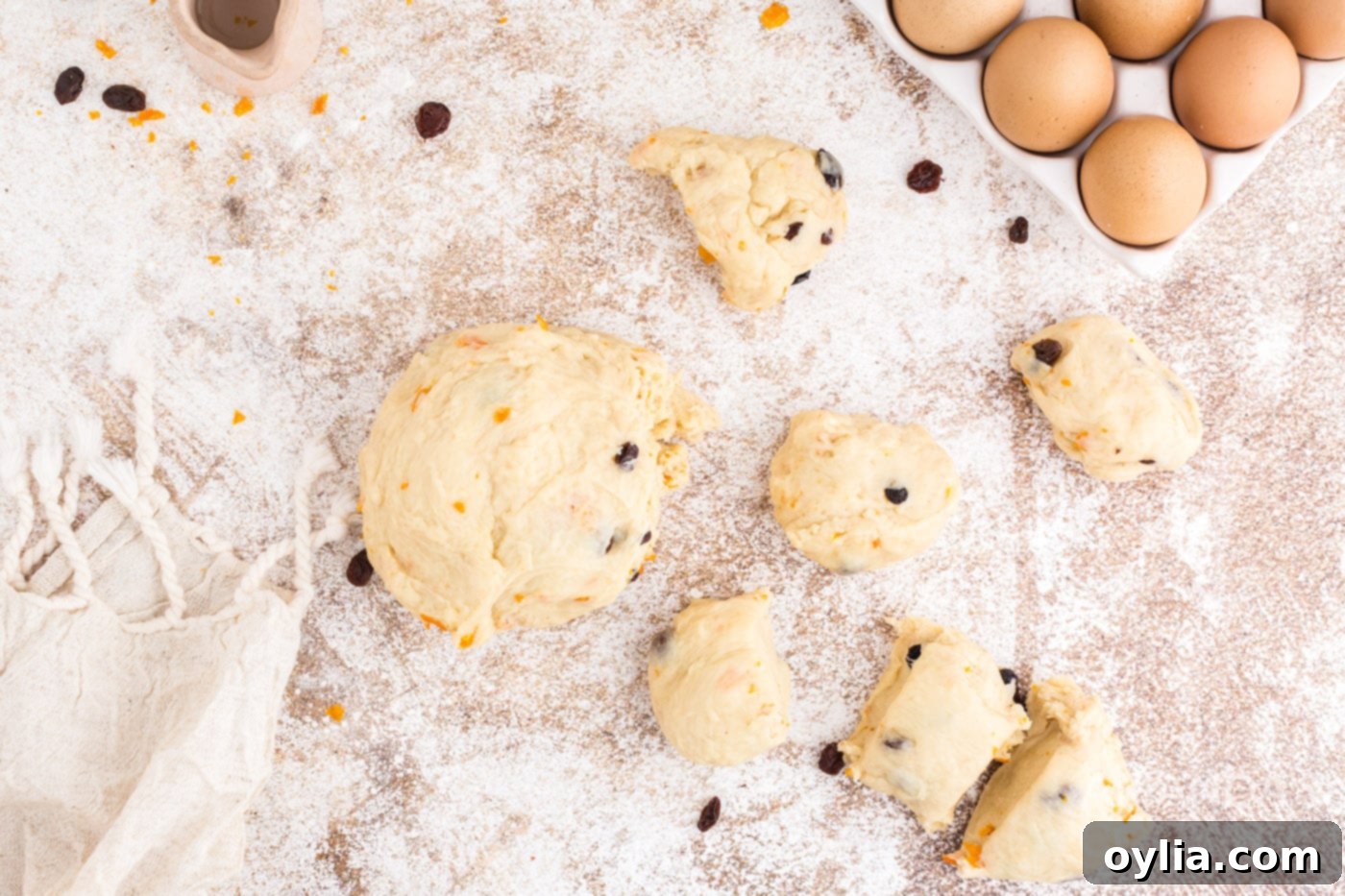Dough divided into 12 equal pieces on a floured surface