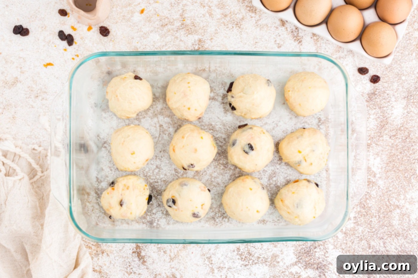 Shaped dough balls placed in a greased baking dish