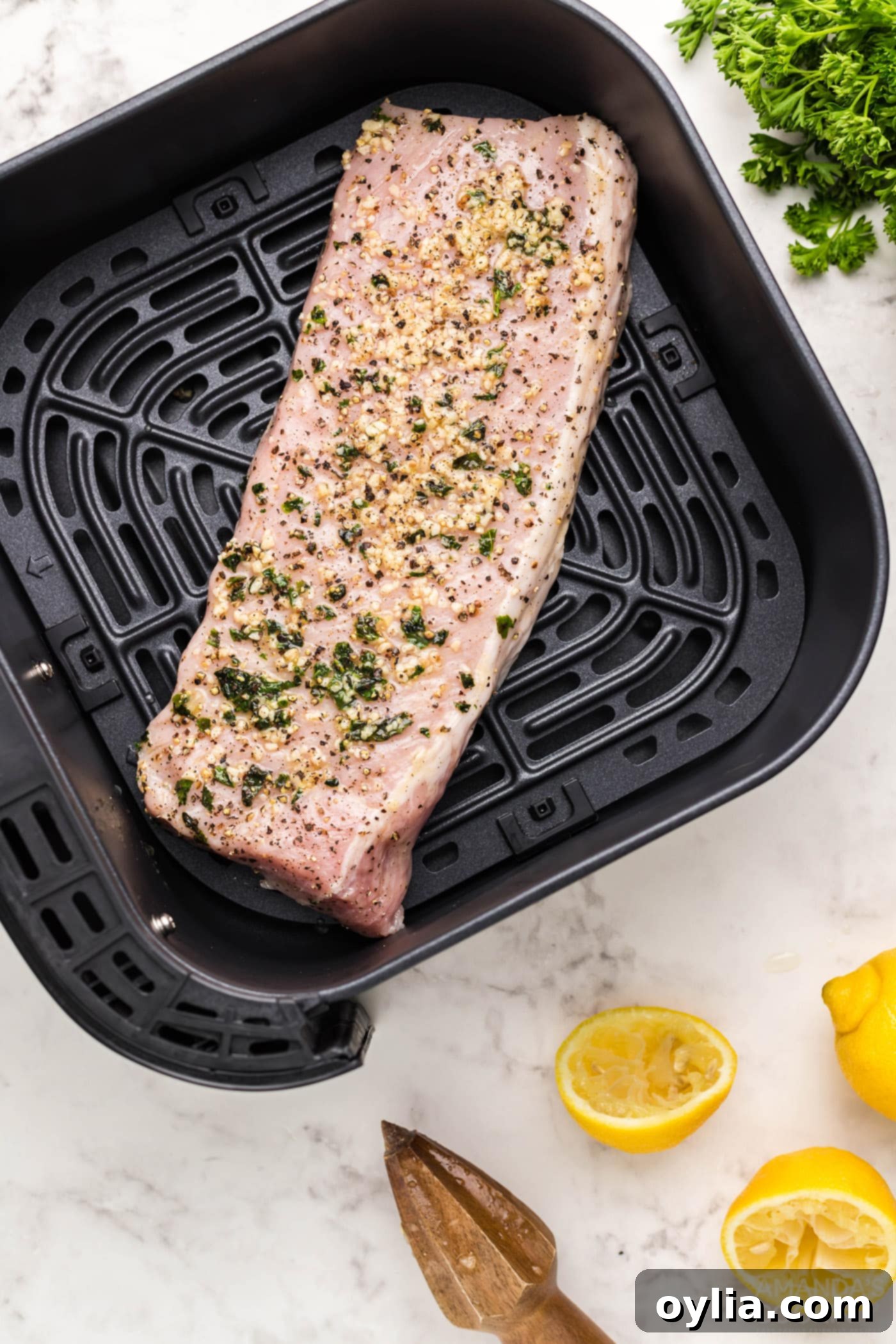 pork tenderloin meat on air fryer grate