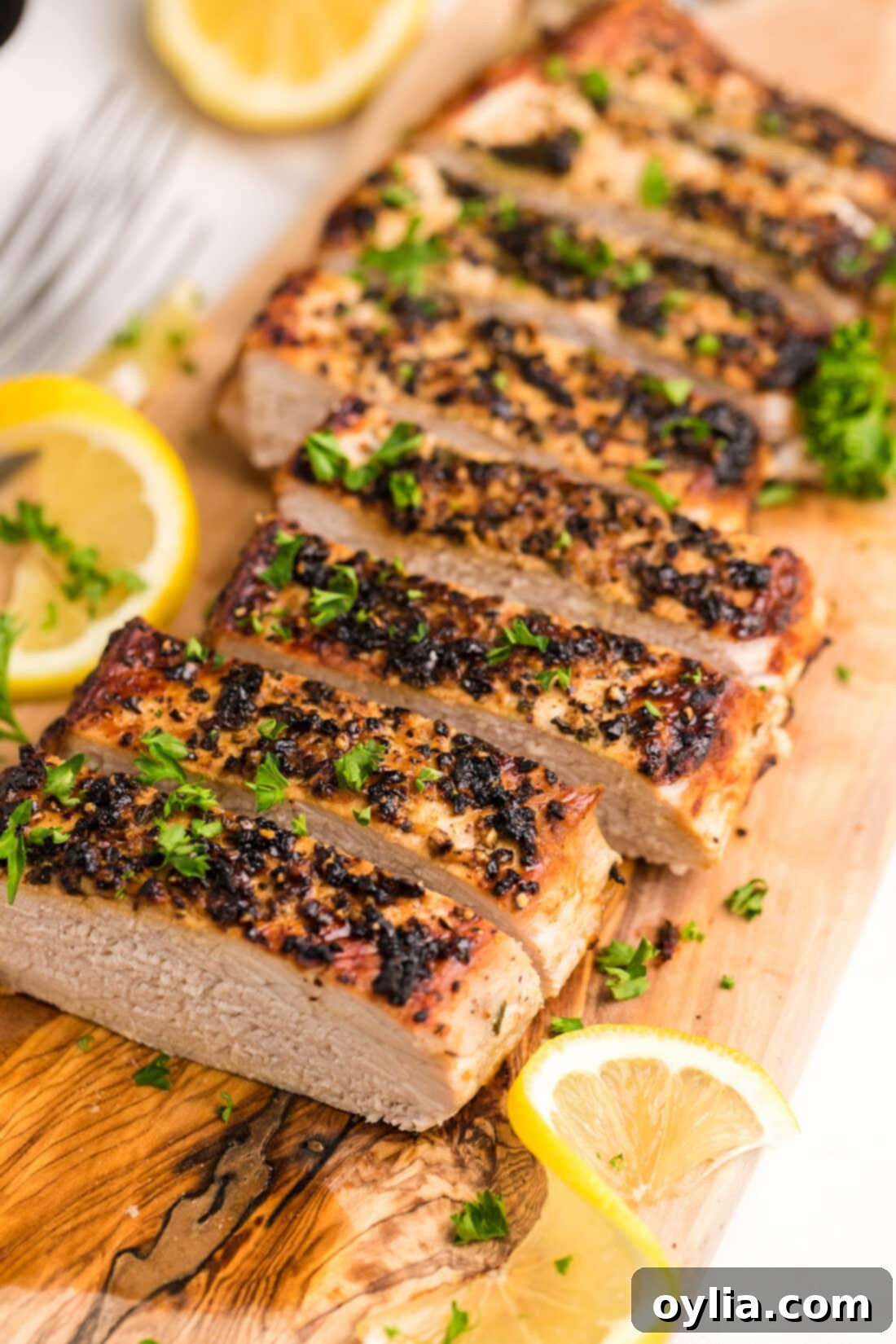 sliced Air Fryer Pork Tenderloin on a cutting board
