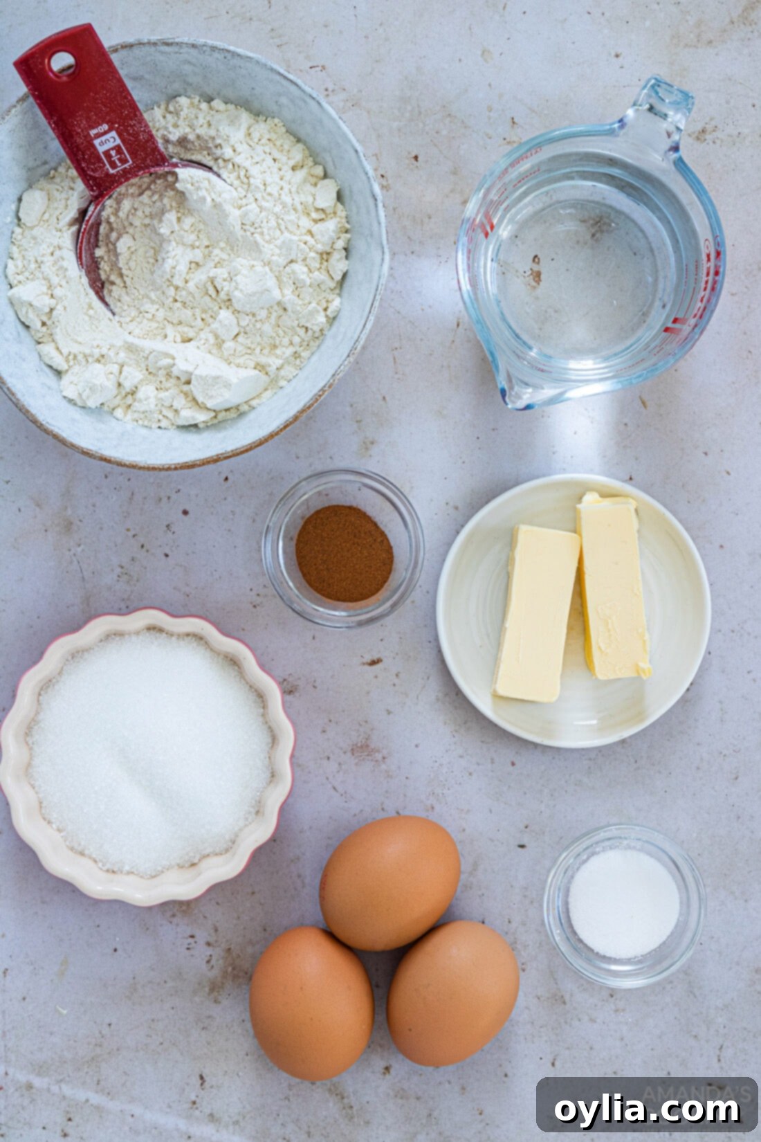 Crispy Air Fryer Churros 4 All the necessary ingredients laid out for making Air Fryer Churros, including flour, butter, sugar, eggs, and cinnamon.