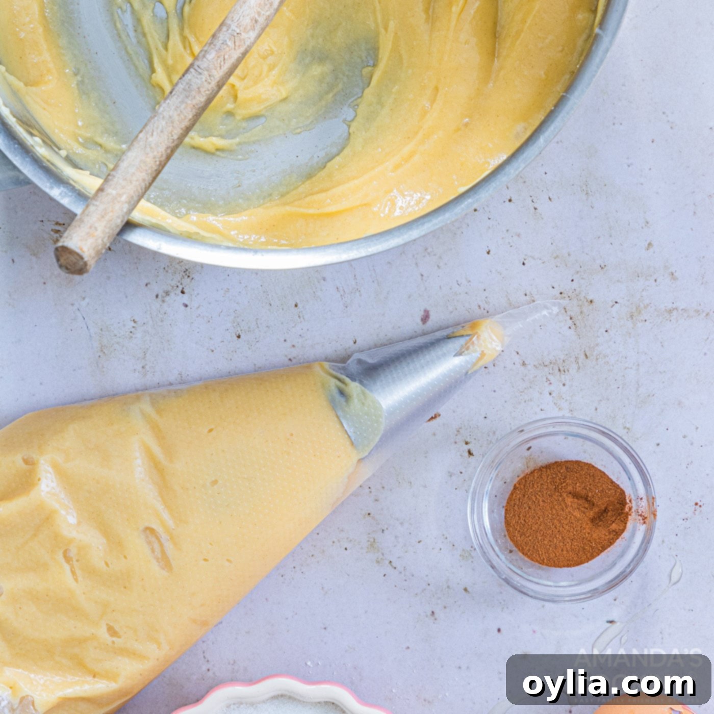 Smooth churro dough loaded into a piping bag with a closed star tip, ready for shaping.