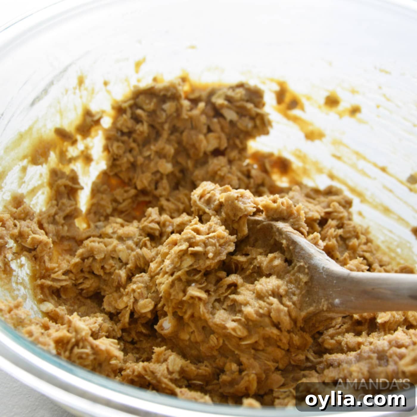 mixing cookie dough with a wooden spoon, showing the consistency