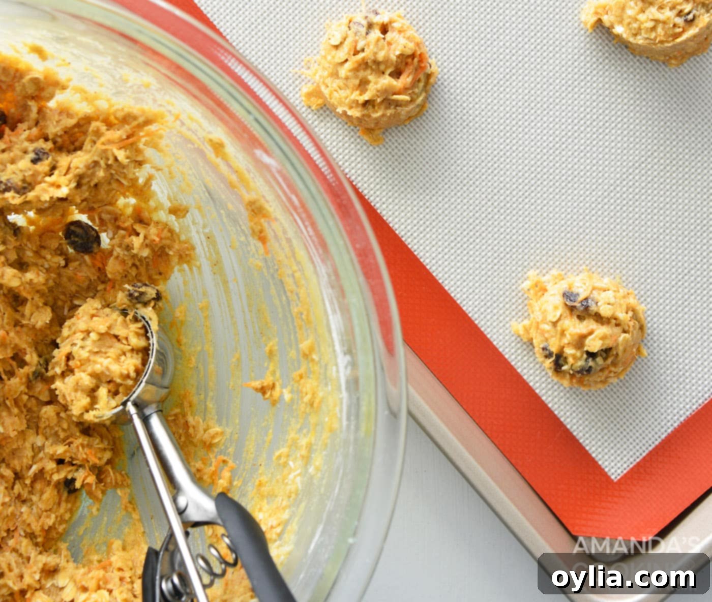 using a cookie scoop to portion dough into balls on a baking sheet