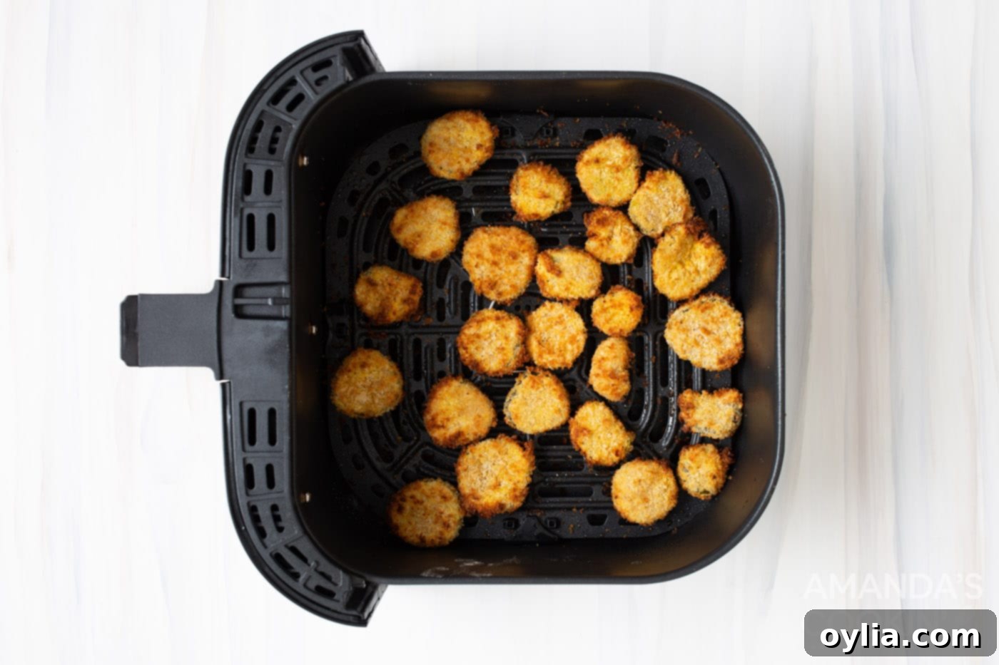 Golden brown, crispy fried pickles after being cooked in an air fryer.