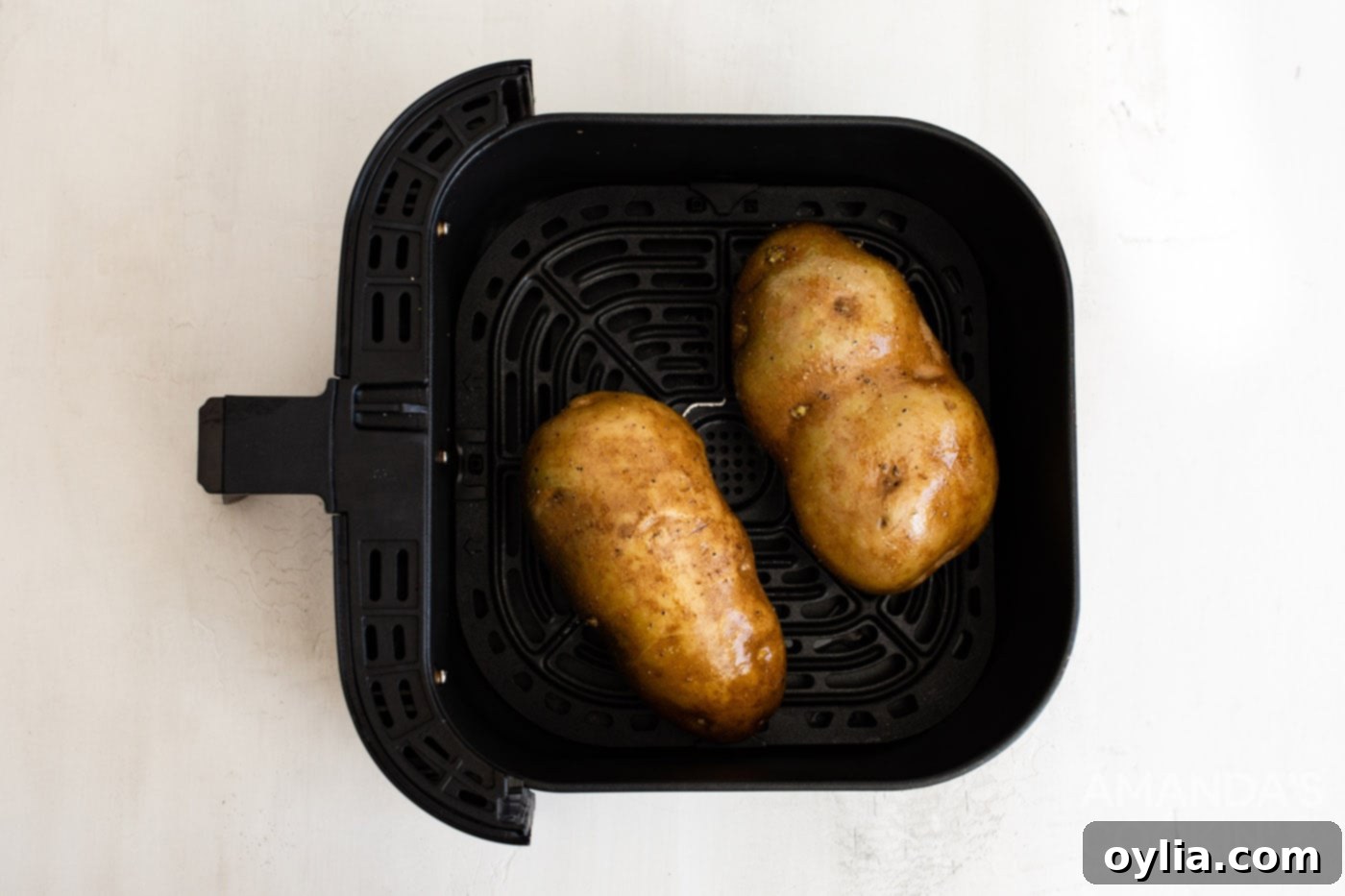 russet potatoes in an air fryer basket