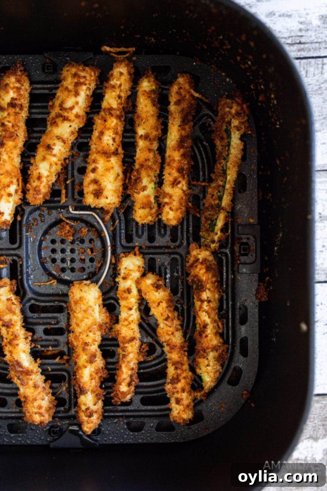 air fryer zucchini fries in an air fryer basket