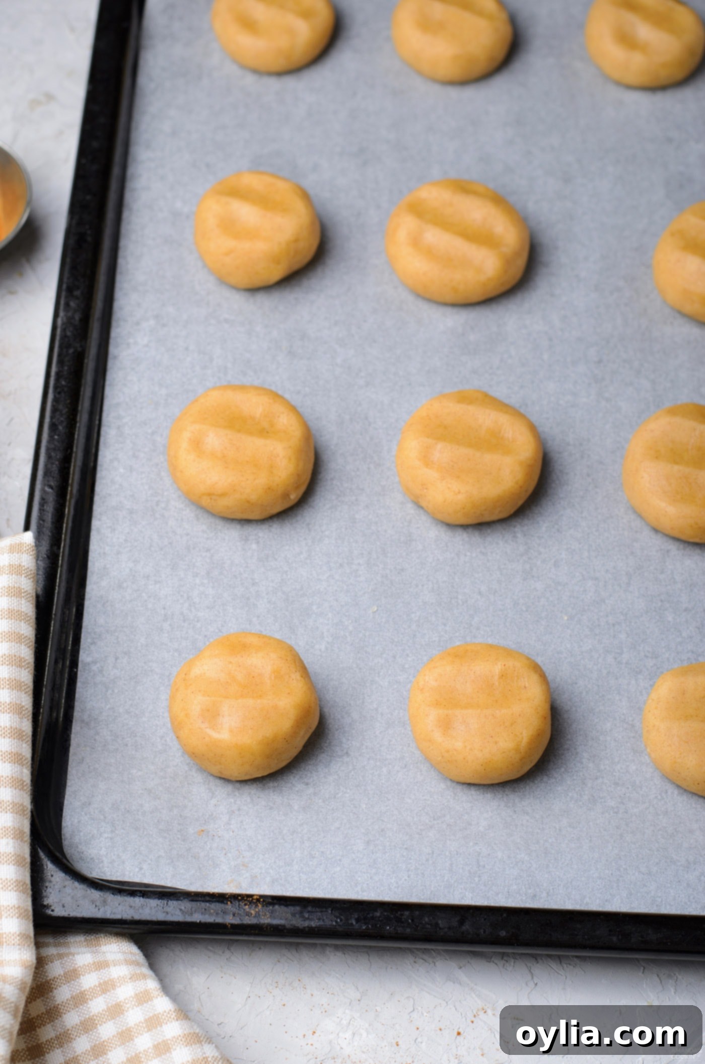 flattened dough balls on baking sheet