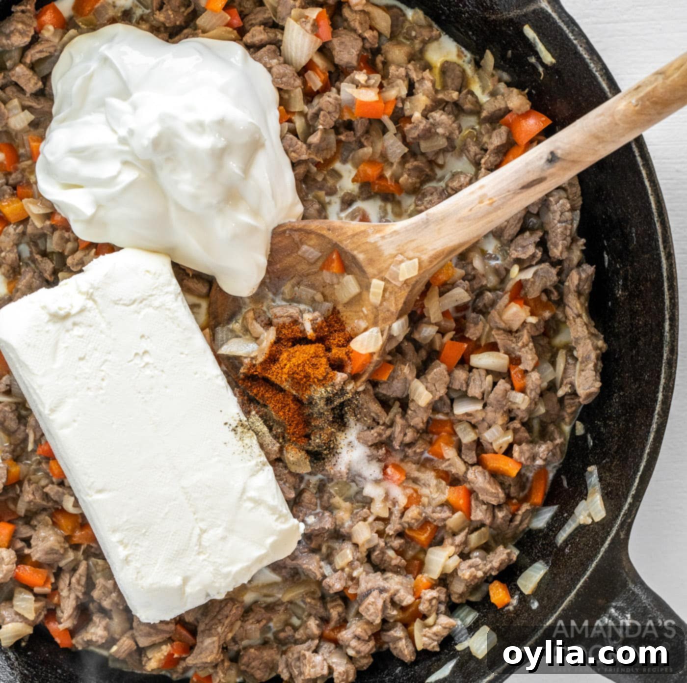 sour cream and cream cheese added to meat mixture in a skillet