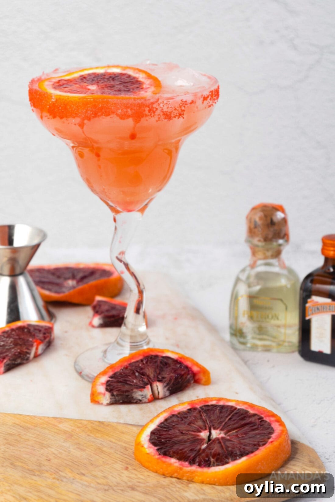 Close-up of a chilled Blood Orange Margarita, showing the vibrant color and sugar rim.