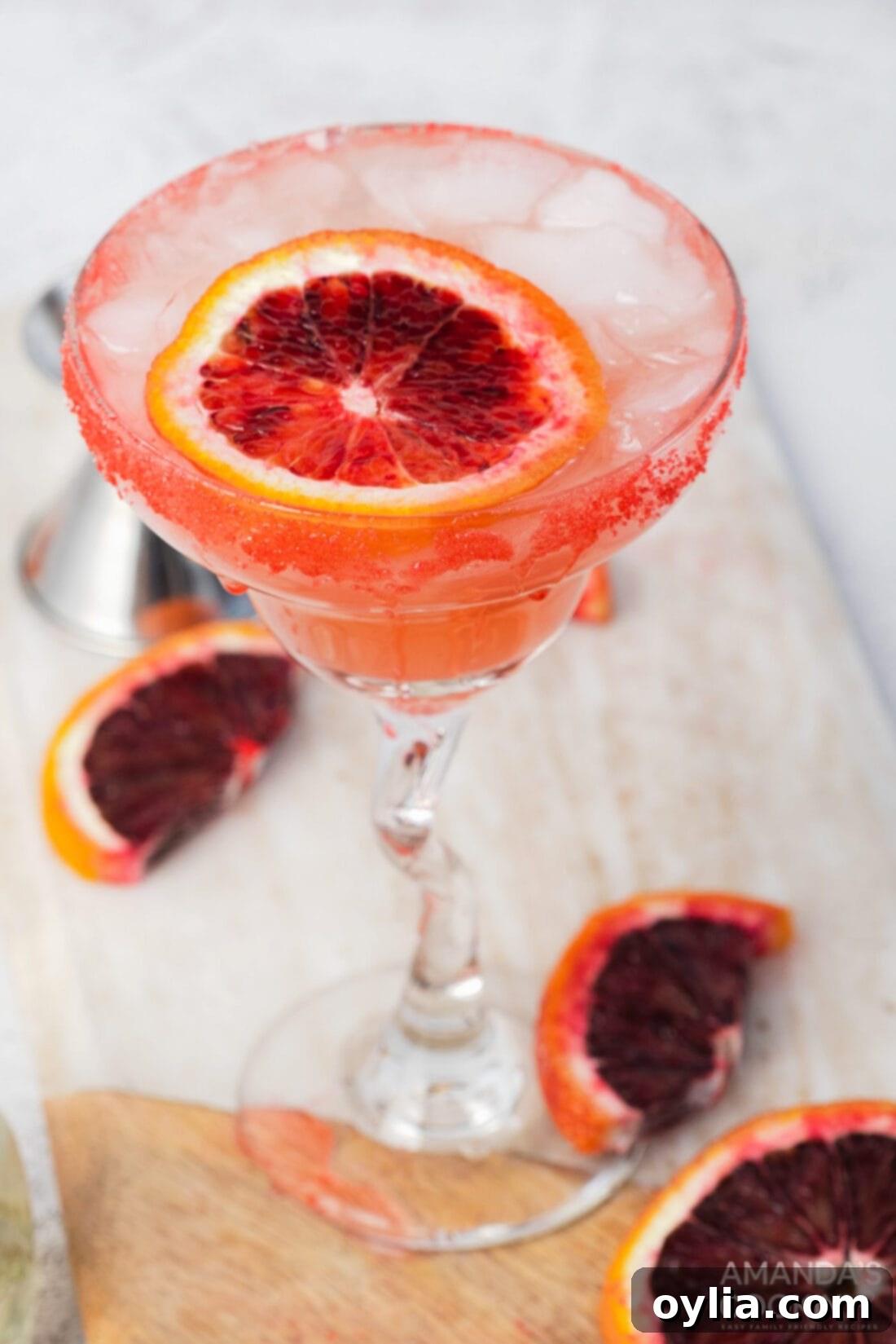 Two Blood Orange Margaritas on a tray, ready to be served, showcasing their beautiful color.
