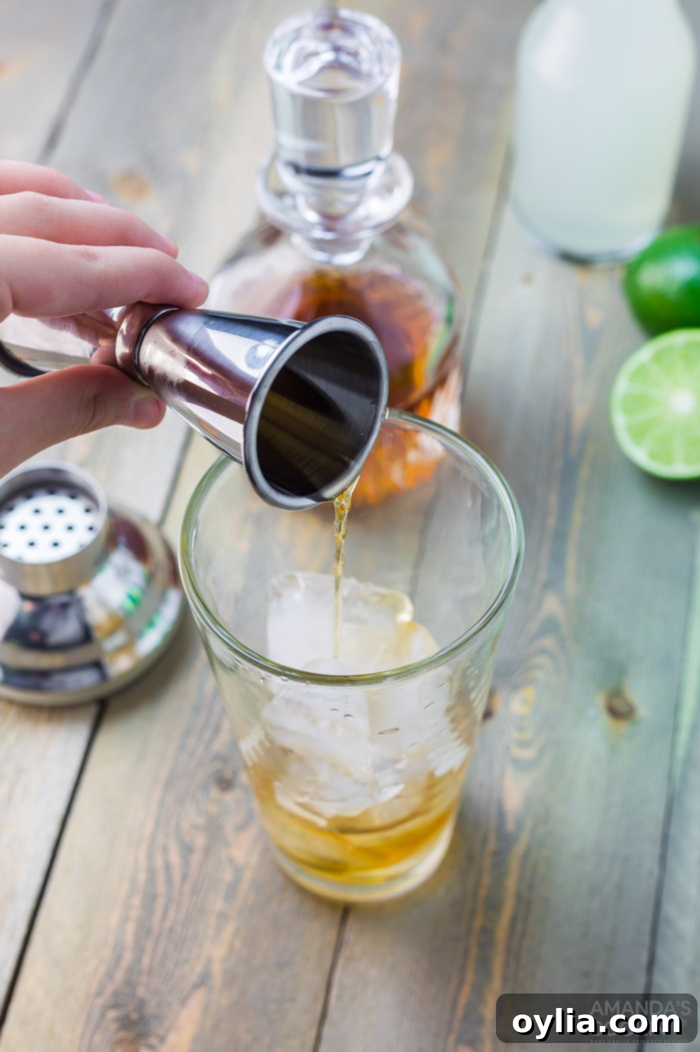 Adding whiskey to a highball glass