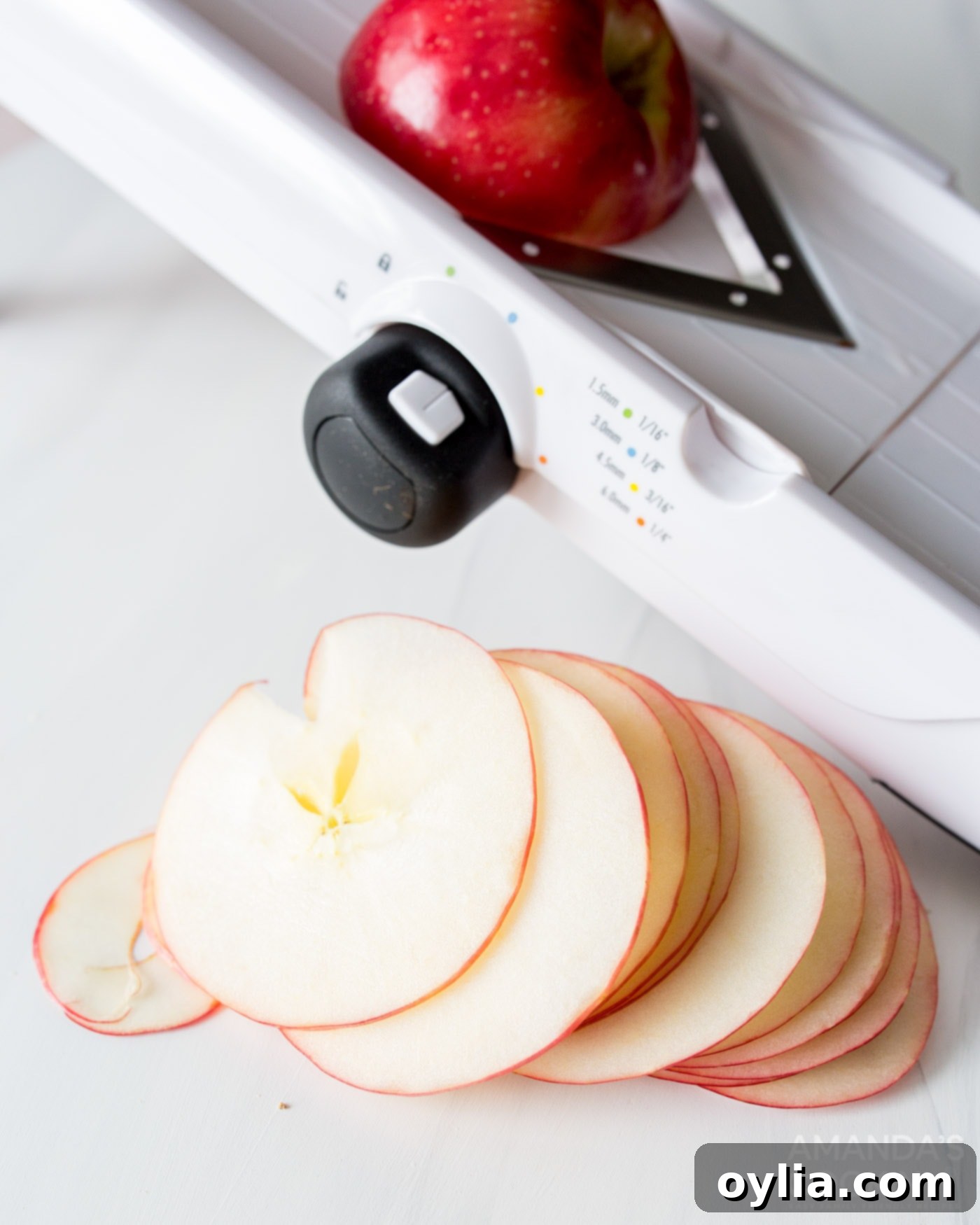 sliced apples next to a mandolin