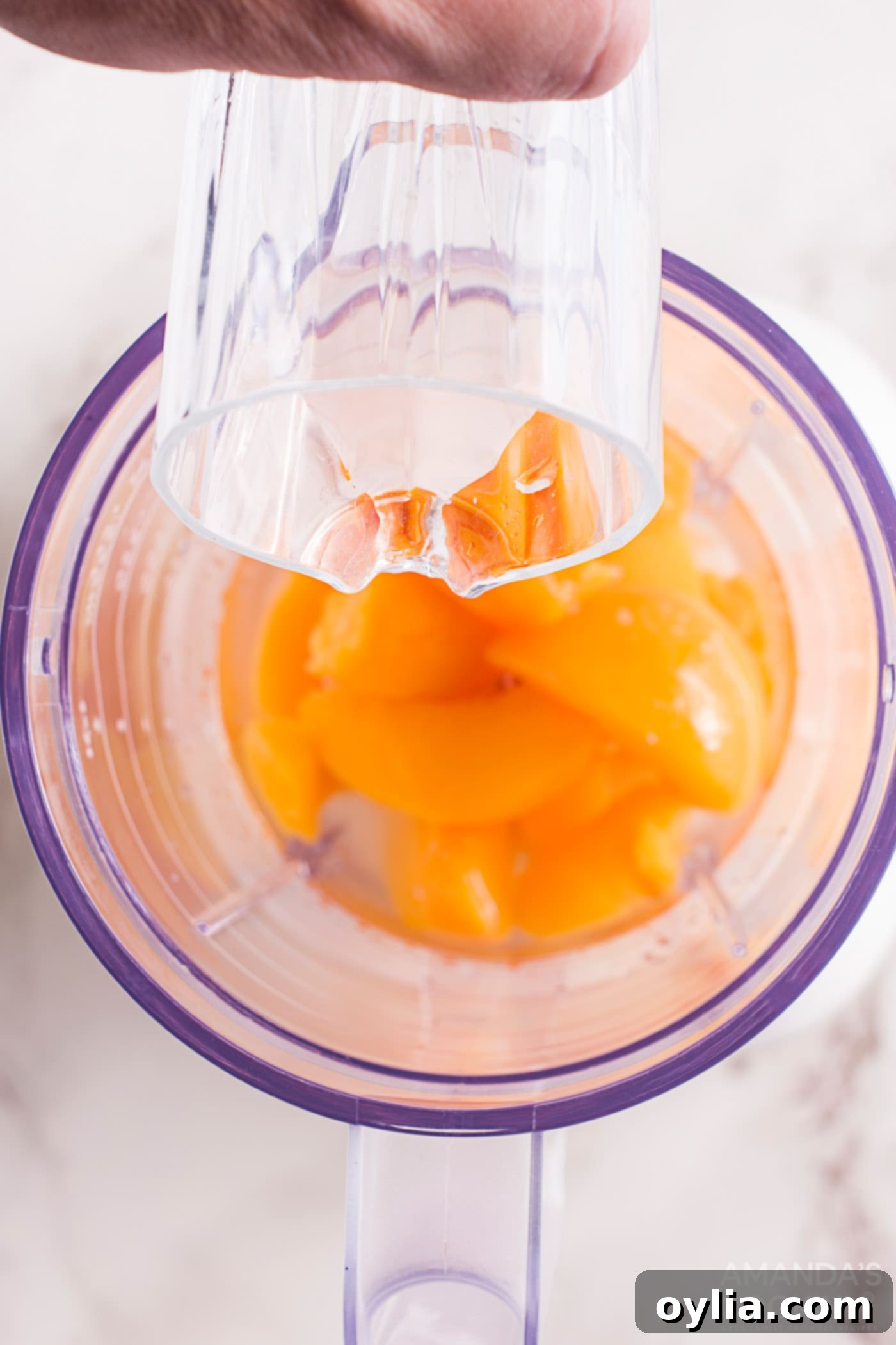 chopped peaches and simple syrup in a blender