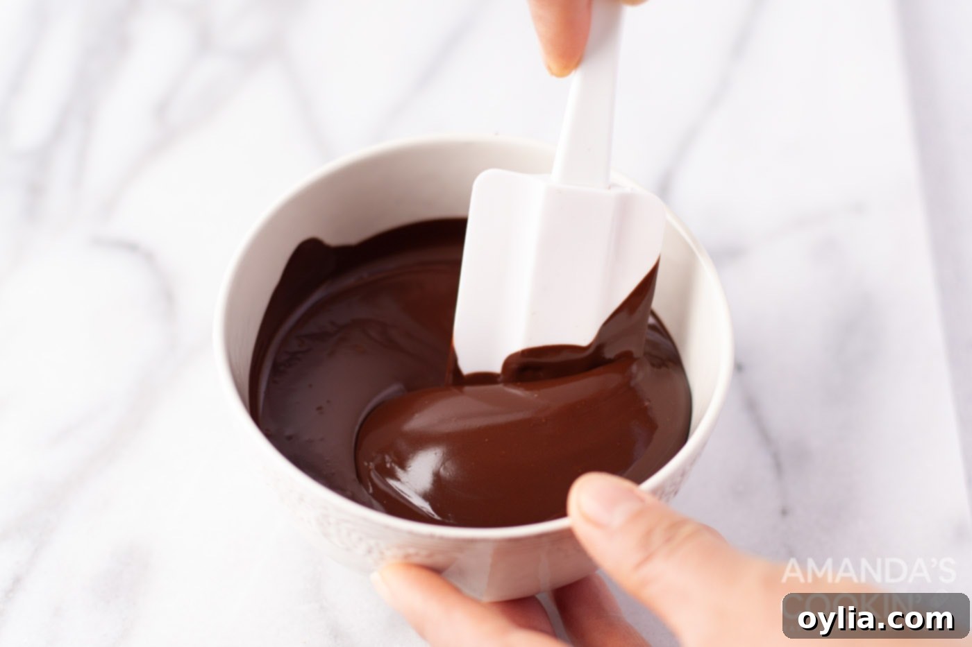 Close-up of rich, dark melted chocolate in a bowl, ready to be mixed for cookies.