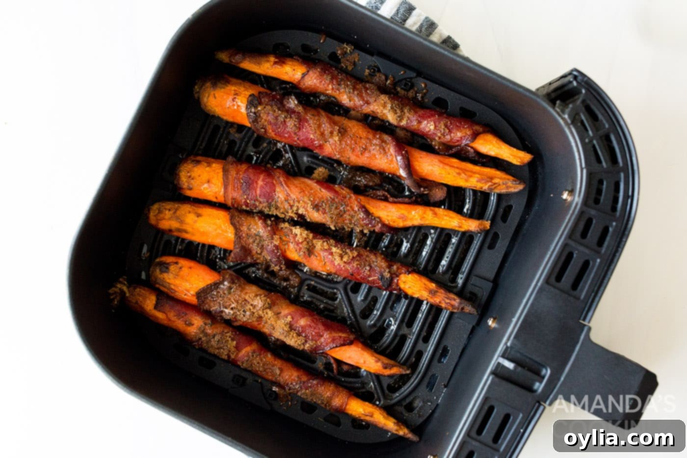 Sweet and Savory Air Fryer Bacon Wrapped Carrots 8 cooked bacon wrapped carrots in air fryer
