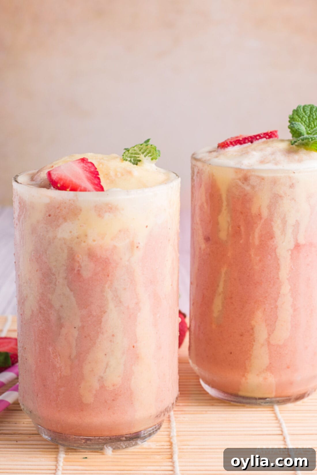 Strawberry Banana Fizzy Floats served in tall glasses with straws