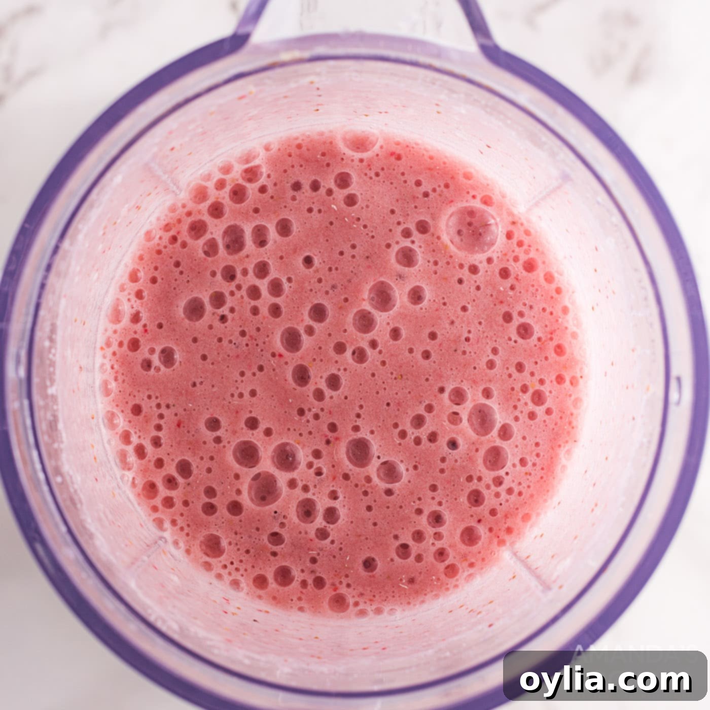 strawberry banana fizzy float mixture in a blender, perfectly blended
