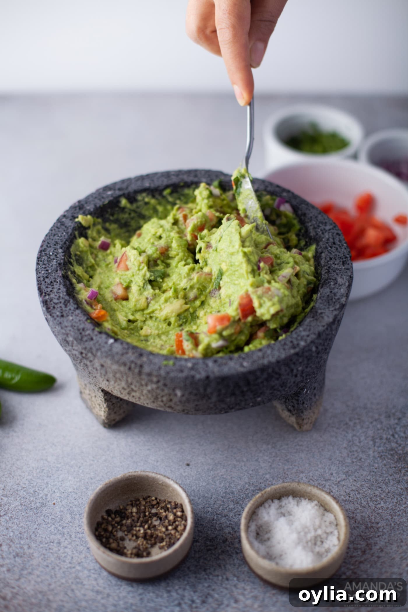 Close-up of freshly mixed guacamole with a spoon, ready to serve