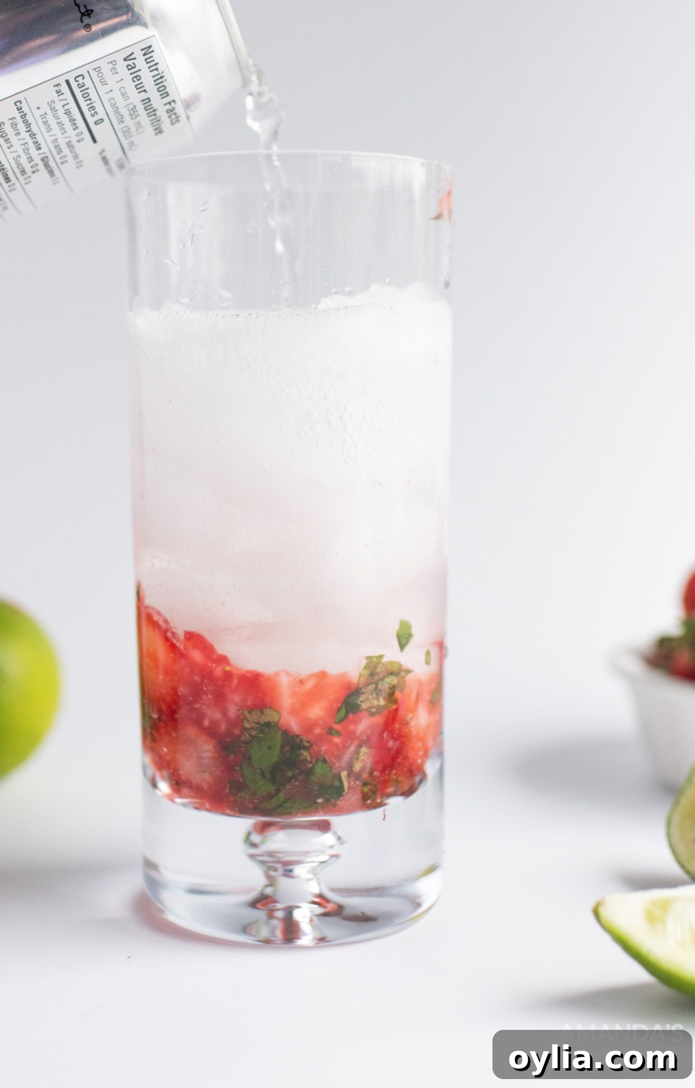 A freshly stirred Strawberry Mojito cocktail, garnished and ready to be enjoyed.