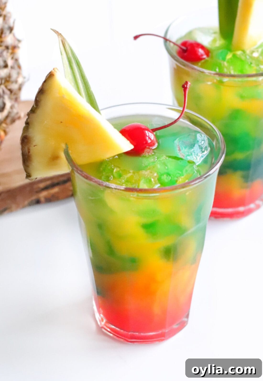Blue Hawaiian Mai Tai garnished with a pineapple wedge and cherry, showcasing its vibrant layers
