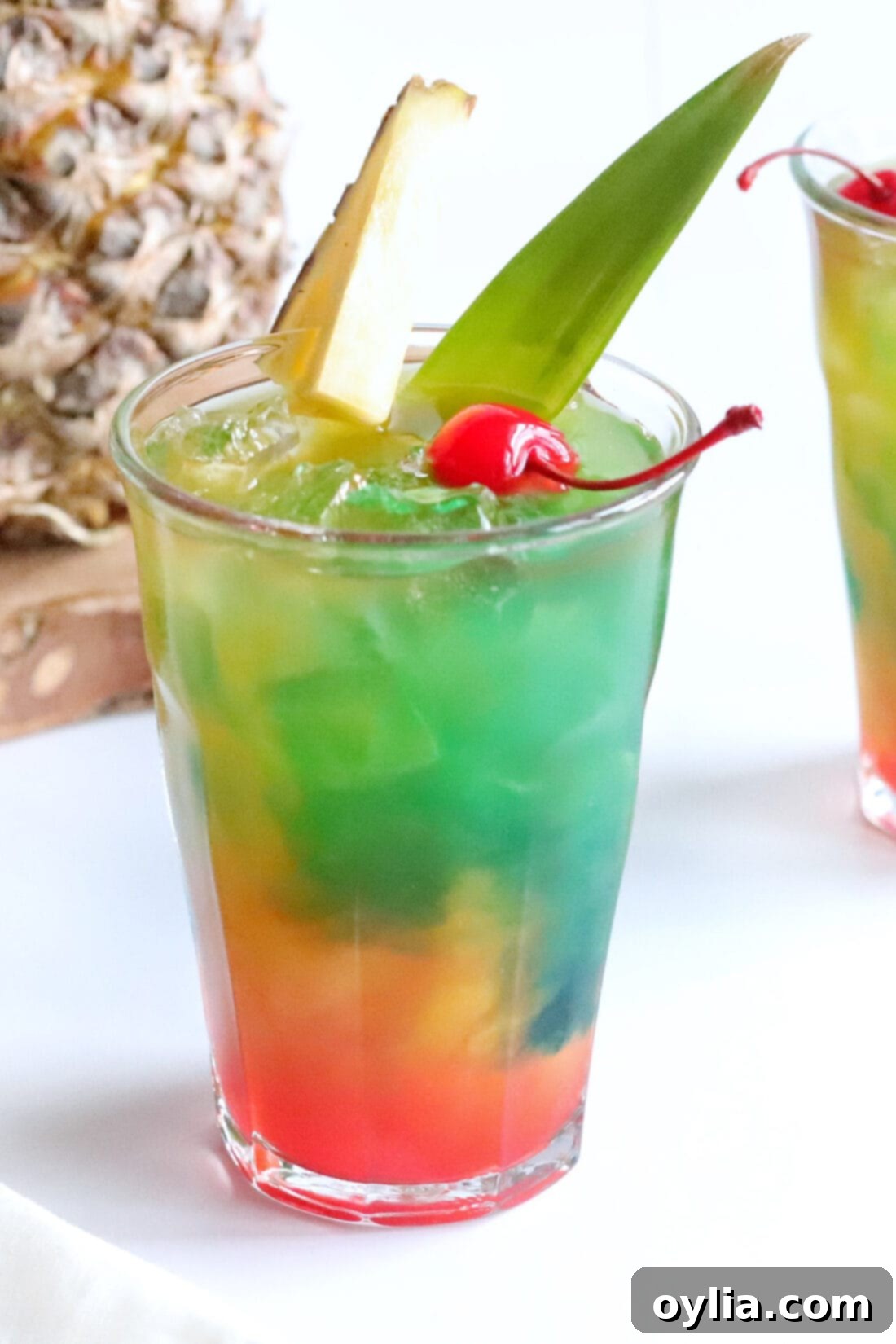 Close up photo of a stunning Blue Hawaiian Mai Tai cocktail, showing its vibrant blue and orange hues