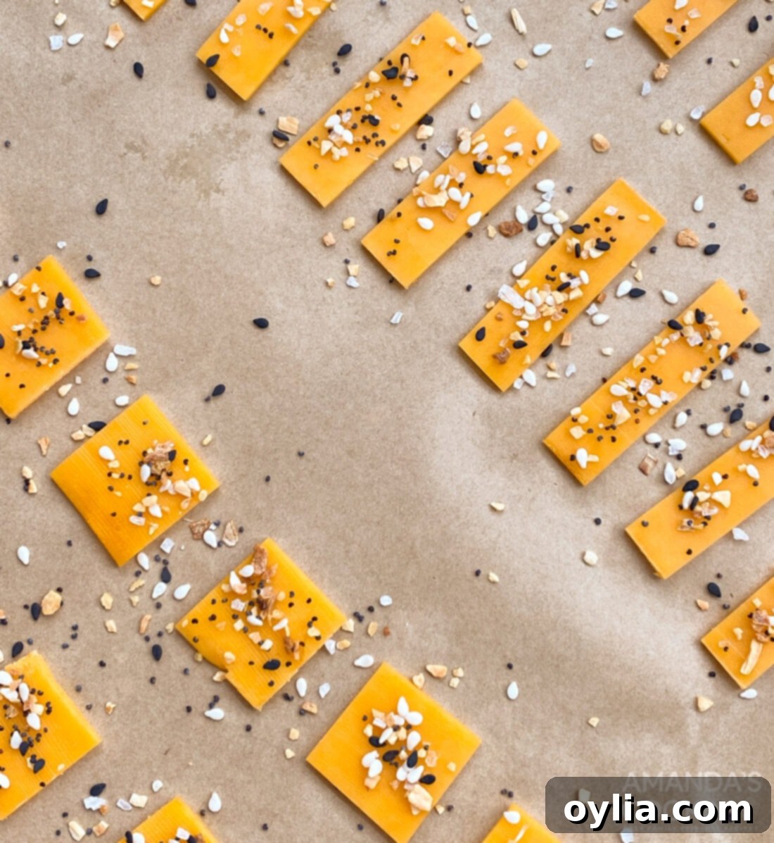slices of cheddar cheese on parchment paper, ready for seasoning