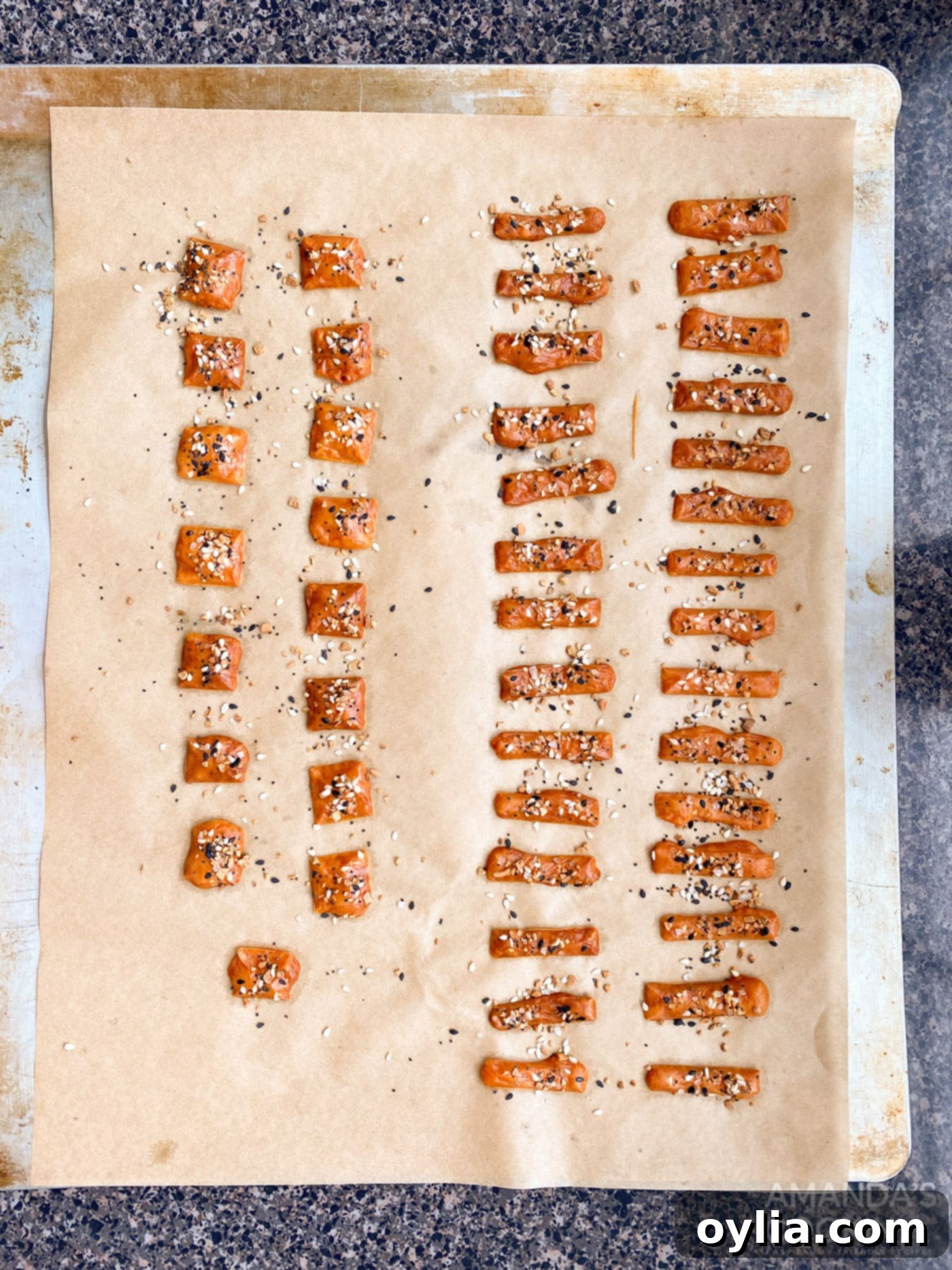 freshly baked, golden cheese squares cooling on a parchment-lined baking sheet