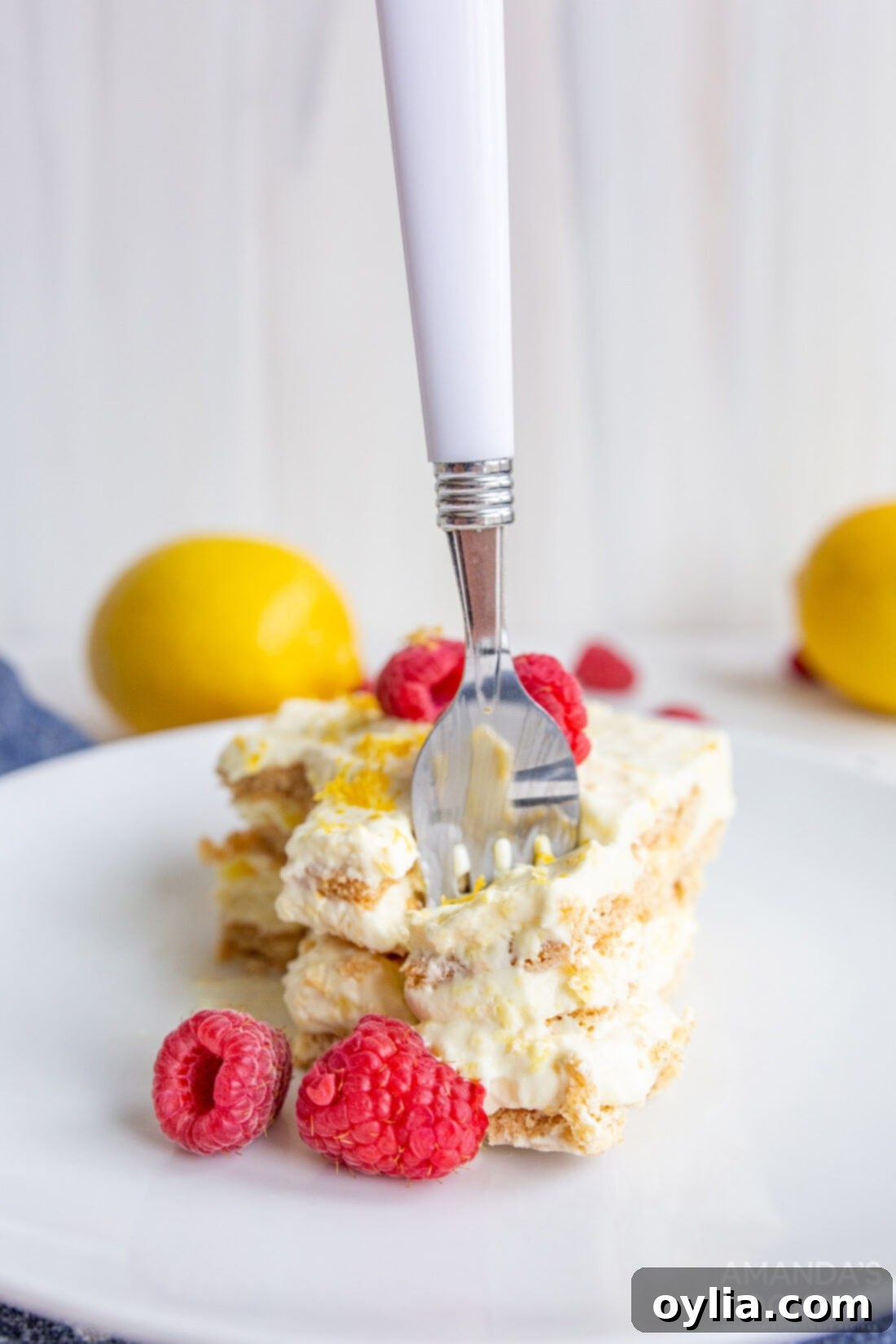 Lemon Icebox Cake 5 fork in slice of lemon icebox cake