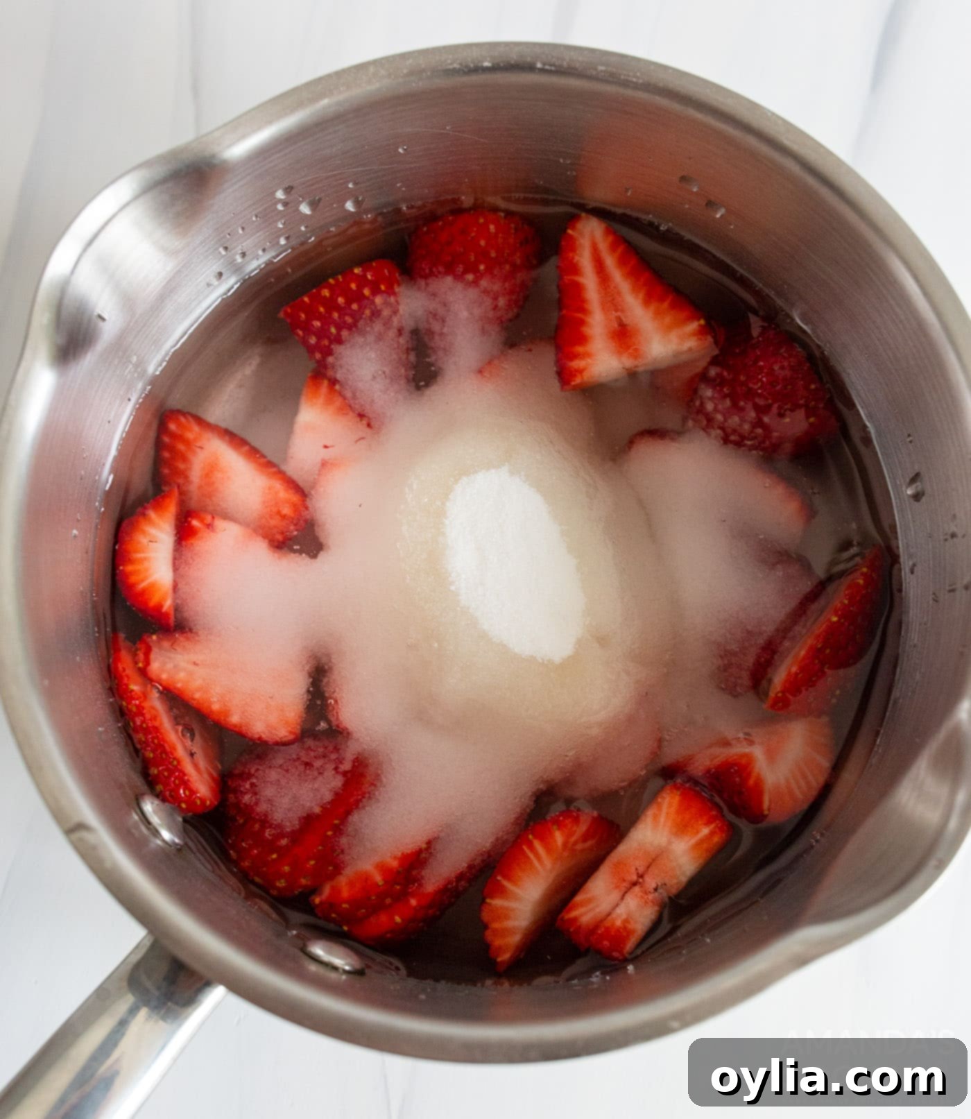 sliced strawberries, sugar, and water in a saucepan