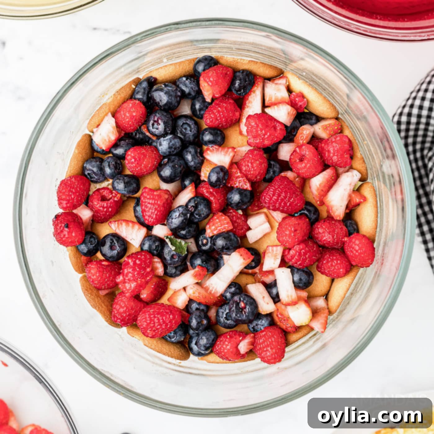 chopped fruit on top of wafers and cake in trifle, followed by jello