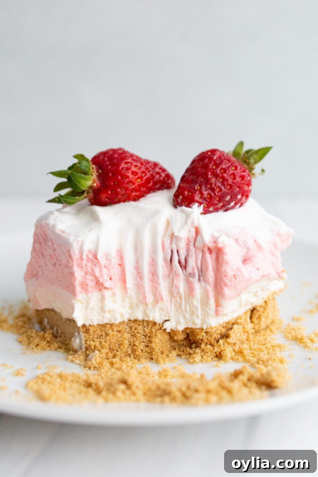 Square of Strawberry Lasagna on a plate with a bite taken out