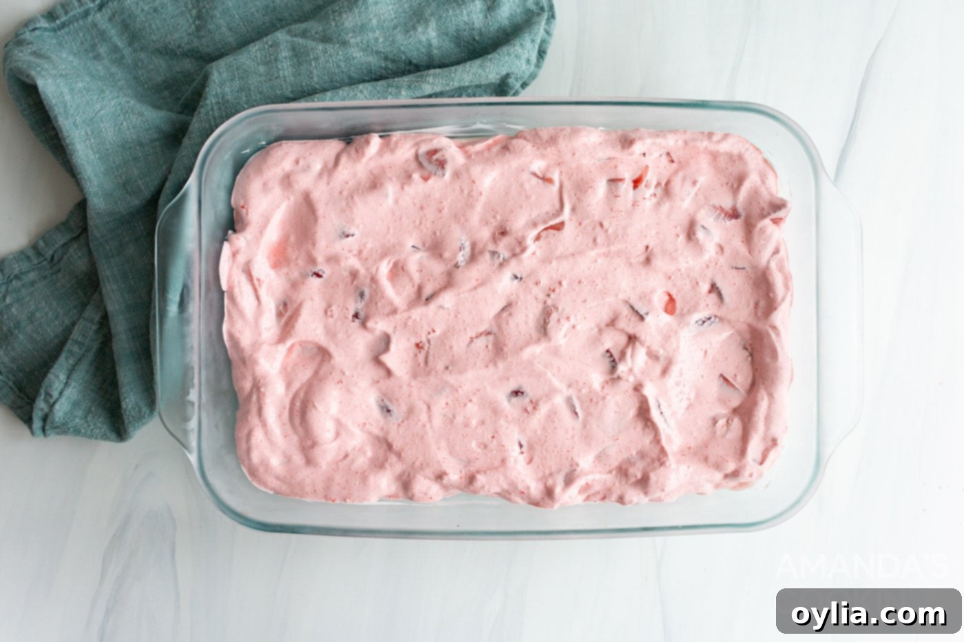 strawberry jello mixture in baking dish