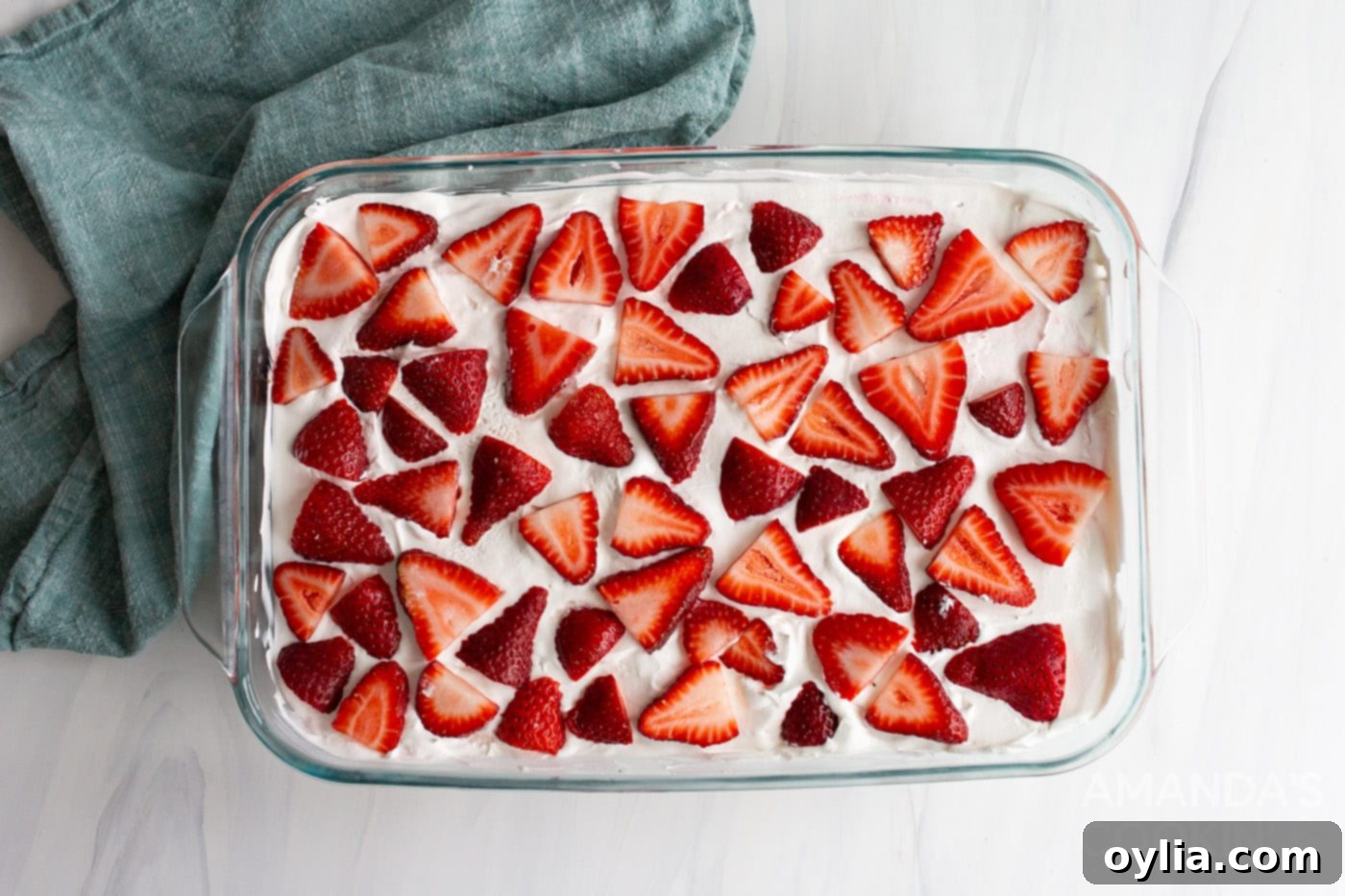 sliced strawberries on top of dessert in a baking dish