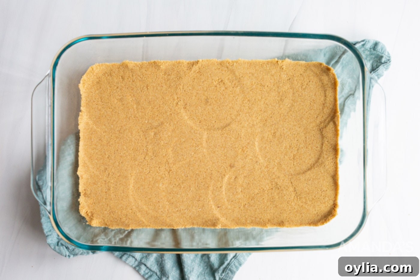 graham cracker forms a crust in a baking dish