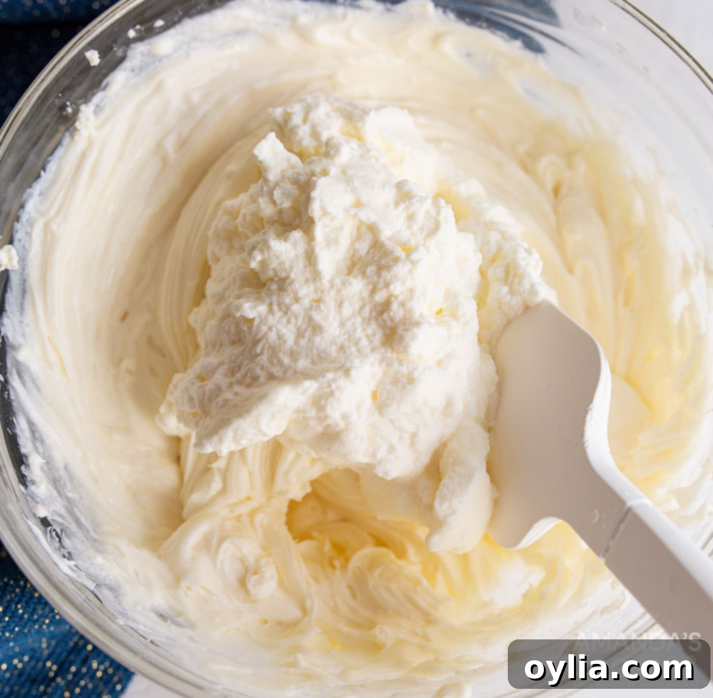 folding together cream cheese mixture into cheesecake mixture