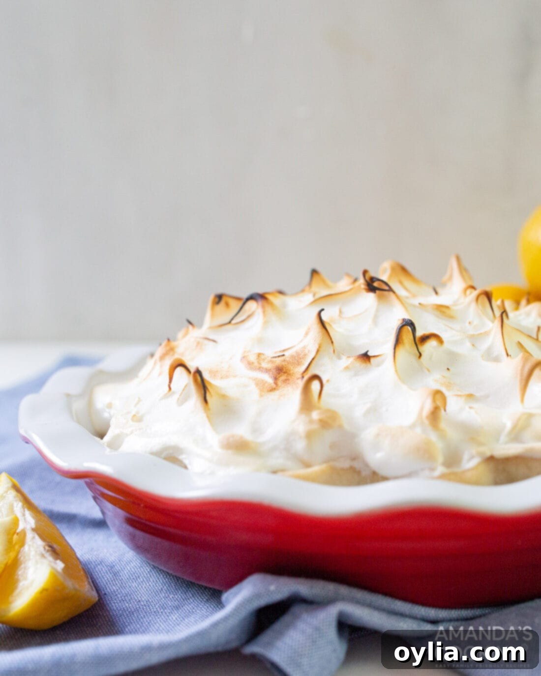 whole lemon meringue pie with browned swirled meringue peaks