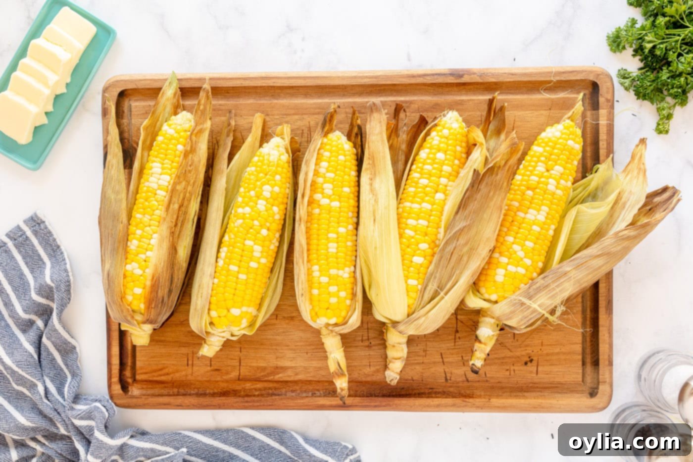 peeled grilled corn on the cob on a cutting board, ready to serve